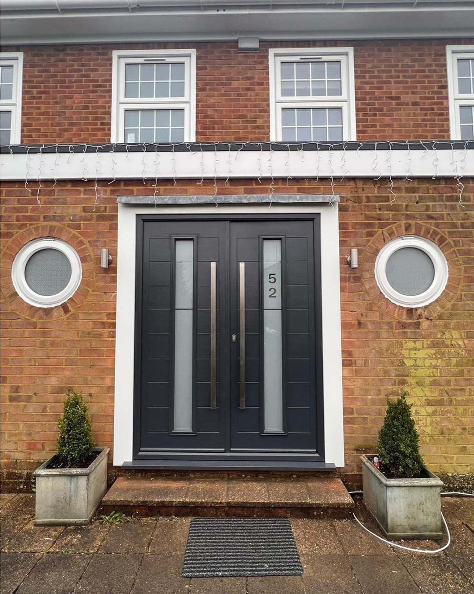 Black double front doors with numbered glass